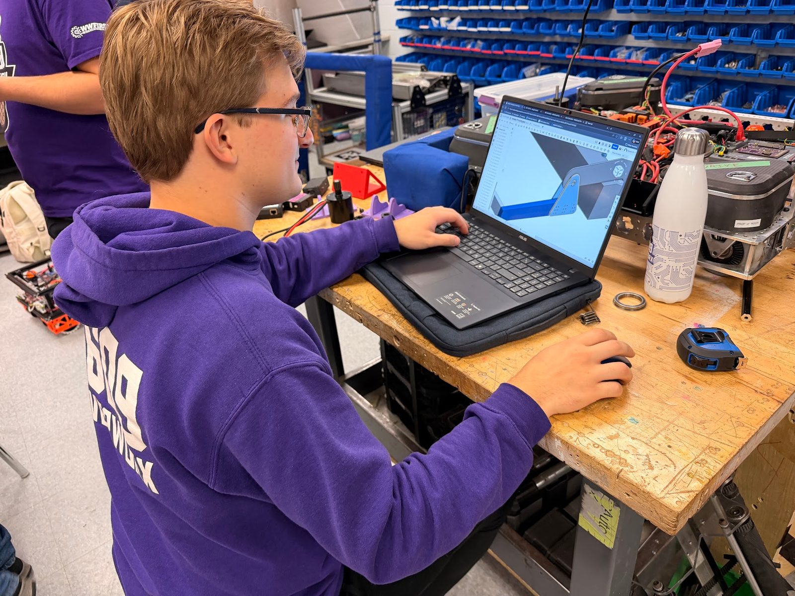 A Team 2609 Beaverworx student reviewing a CAD model during build season