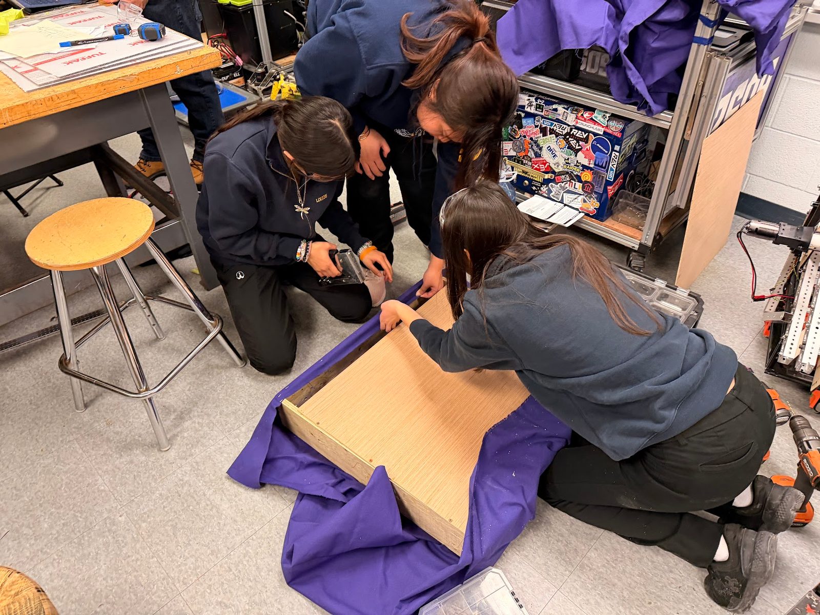 Team 2609 Beaverworx students building a robot bumper together